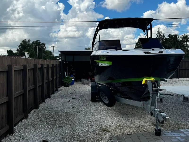 Slide: The Image of 2021 Yamaha AR250 boat on trailer in driveway, under cloudy sky. - 3
