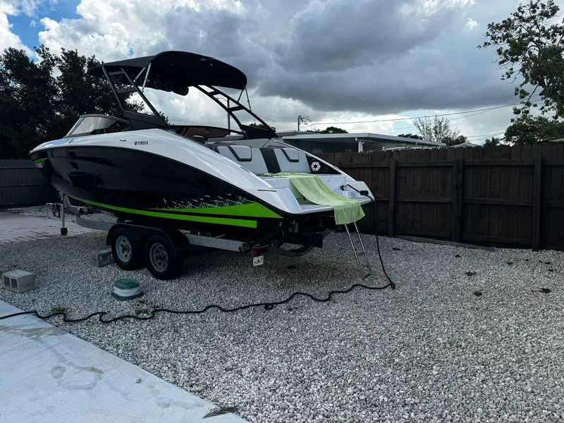 Slide: The Image of 2021 Yamaha AR250 boat on trailer, parked on gravel, under cloudy sky. - 4