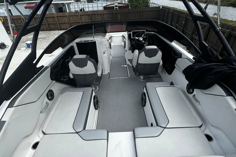 Slide: The Image of 2021 Yamaha Boats AR250 interior with spacious seating and modern design. - 5