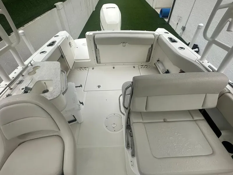 Slide: The Image of 2020 Boston Whaler 230 Vantage boat interior with white seating and spacious layout. - 10