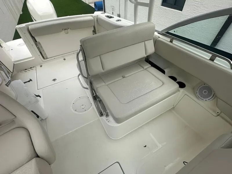 Slide: The Image of 2020 Boston Whaler 230 Vantage boat interior with white seating and storage compartments. - 11
