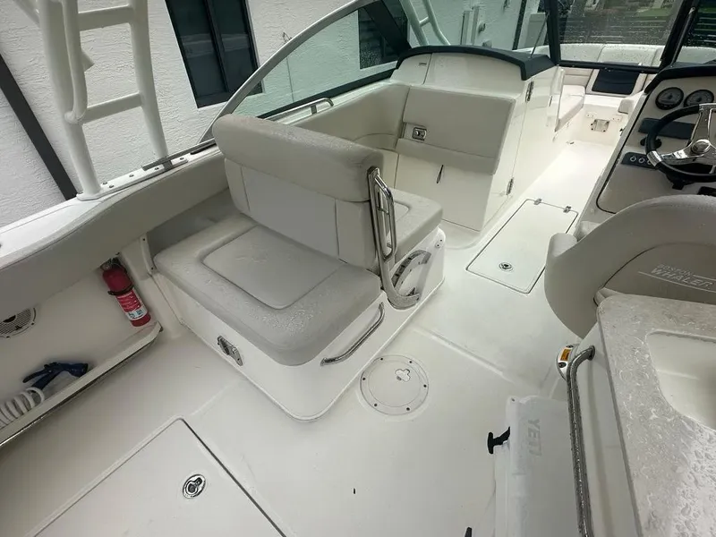 Slide: The Image of 2020 Boston Whaler 230 Vantage interior, featuring seating and helm area. - 12