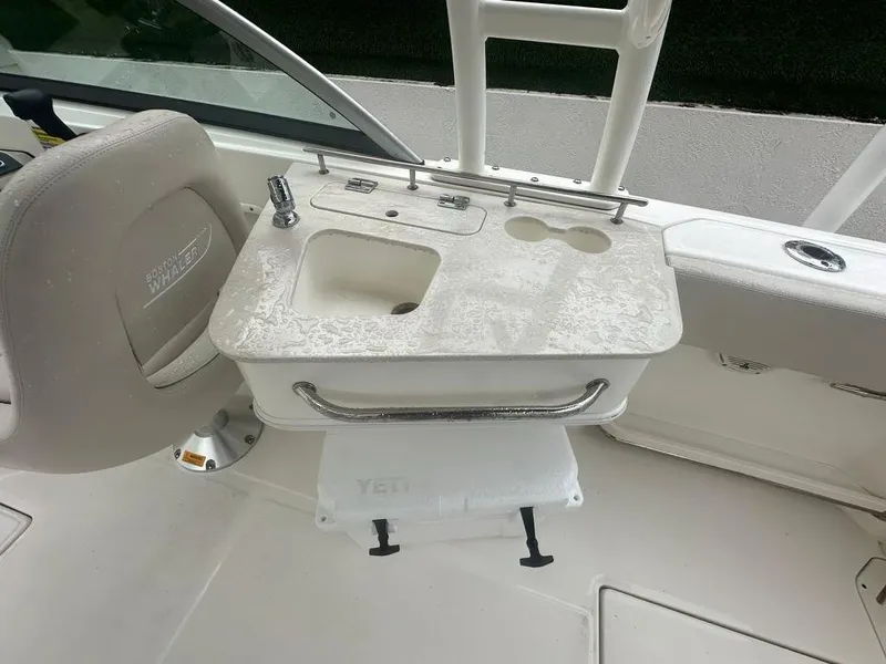 Slide: The Image of 2020 Boston Whaler 230 Vantage boat interior with sink and seating area. - 14