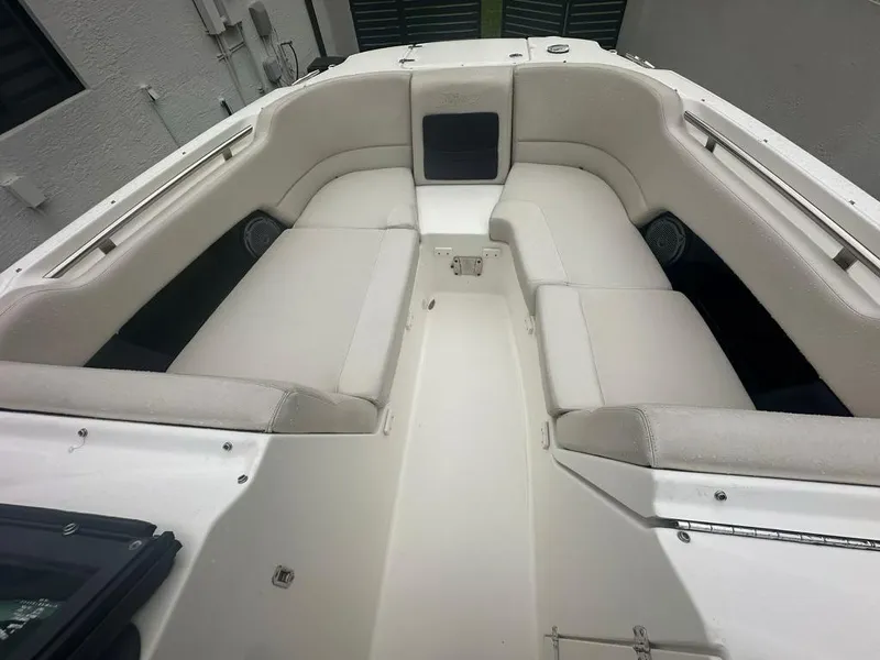 Slide: The Image of 2020 Boston Whaler 230 Vantage boat interior with white cushioned seating. - 16