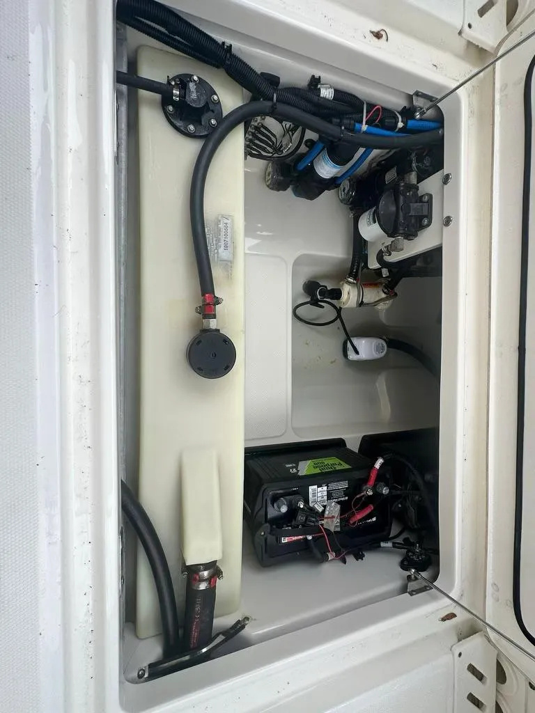 Slide: The Image of 2020 Boston Whaler 230 Vantage engine compartment with wiring and components. - 19