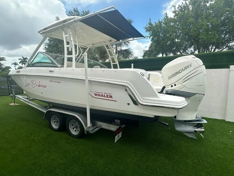 Slide: The Image of 2020 Boston Whaler 230 Vantage boat on trailer, featuring Mercury outboard engine. - 3