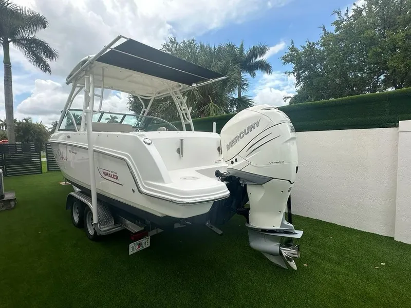 Slide: The Image of 2020 Boston Whaler 230 Vantage boat with Mercury engine on trailer, parked on grass. - 6