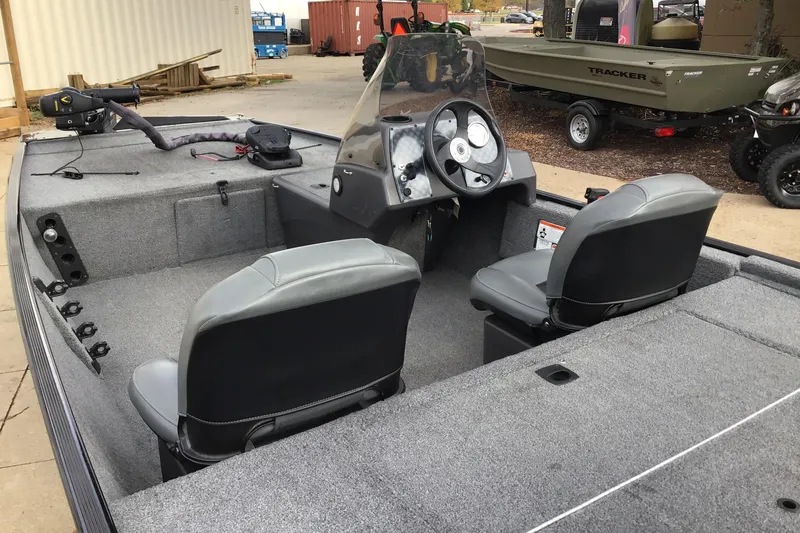 Slide: The Image of 2020 Tracker BASS TRK CL XL boat interior with dual seats and steering console. - 3