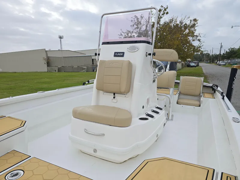Slide: The Image of 2022 Avid 21 Mag boat with beige seating and white deck, parked outdoors. - 24