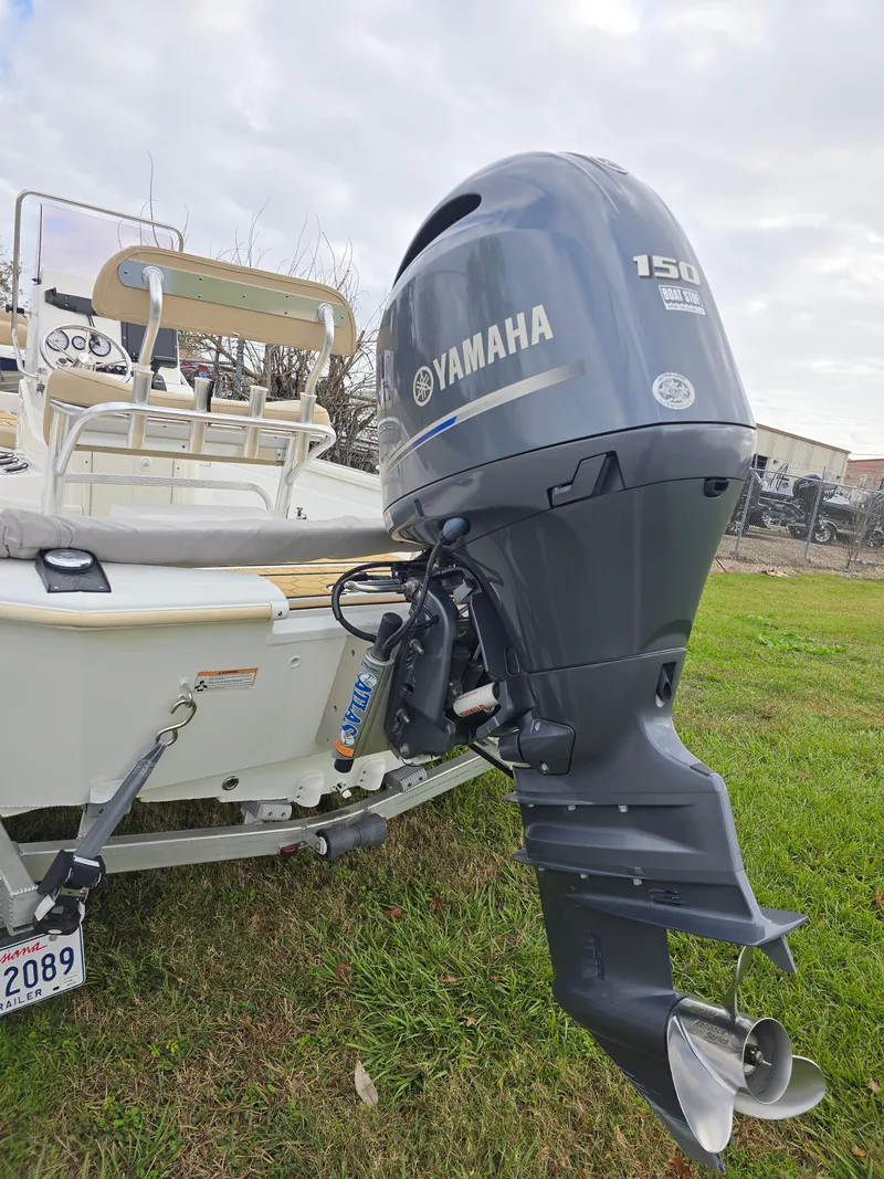 Slide: The Image of Avid 21 Mag 2022 boat with Yamaha 150 outboard motor on grass. - 27