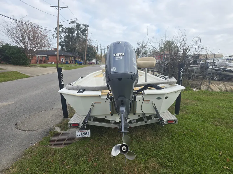 Slide: The Image of 2022 Avid 21 Mag boat with Yamaha 150 engine, parked on grass. - 5