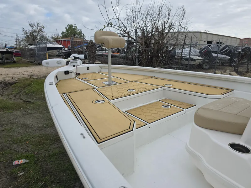 Slide: The Image of Avid 21 Mag 2022 boat with tan deck, fishing seat, and storage compartments. - 8