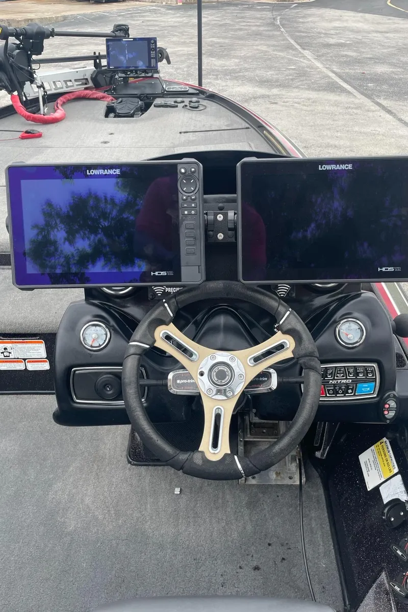 Slide: The Image of 2016 Nitro Z21 XL Pro boat dashboard with dual Lowrance displays and steering wheel. - 1