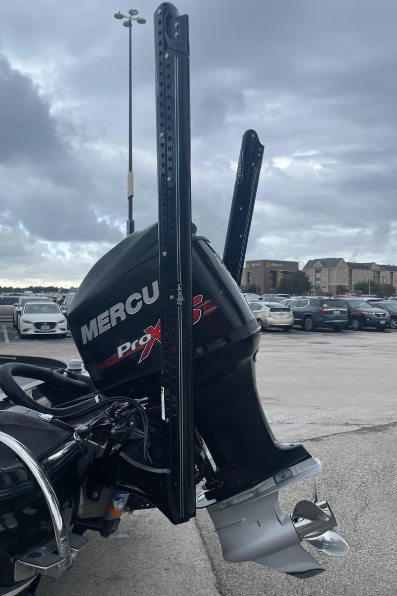 Slide: The Image of 2016 Nitro Z21 XL Pro boat with Mercury Pro XS outboard motor in parking lot. - 2