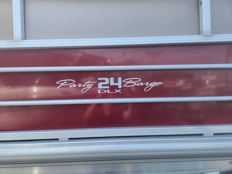 Slide: The Image of 2019 Sun Tracker 24 DLX Party Barge logo on red panel. - 9