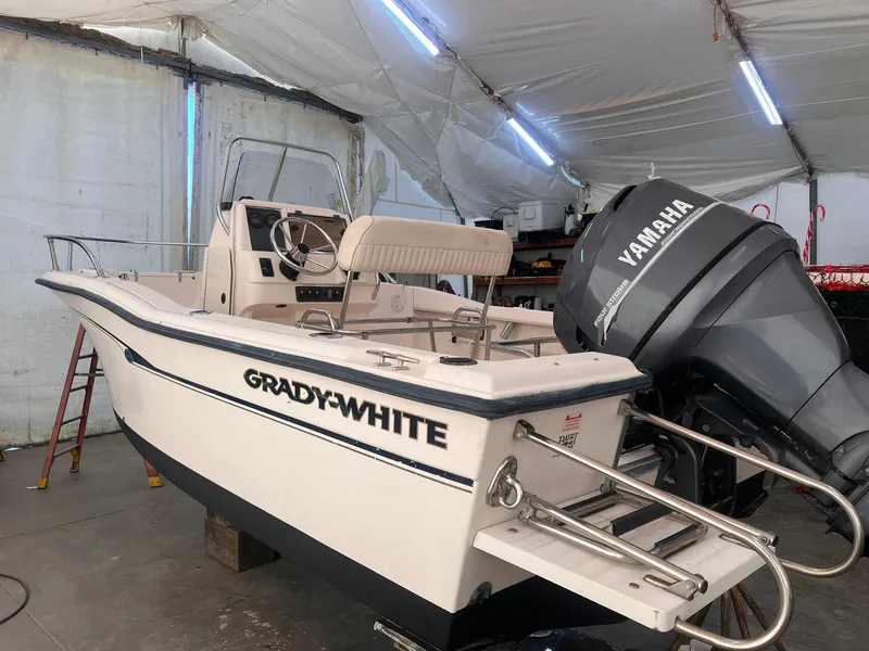 Slide: The Image of 2001 Grady-White Sportsman 180 boat with Yamaha outboard motor in a covered storage area. - 10