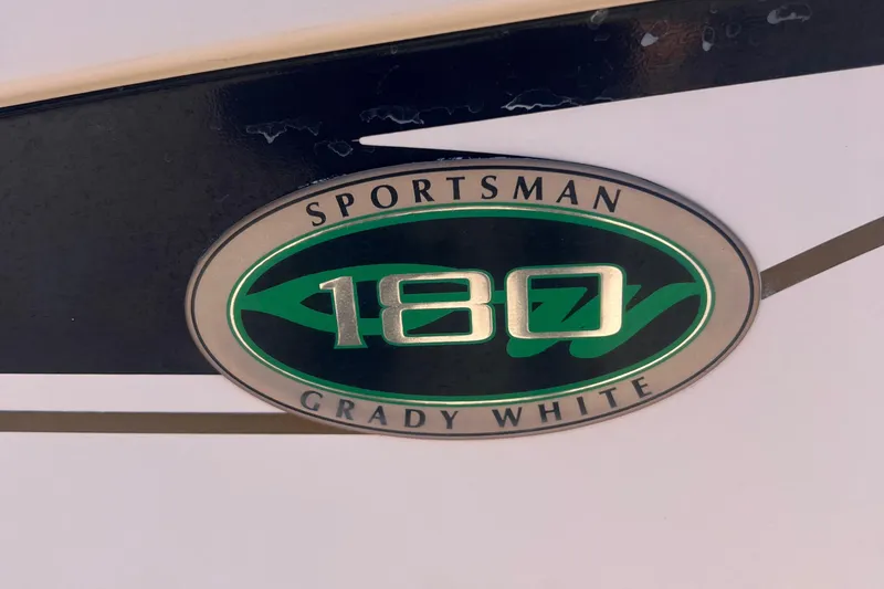 Slide: The Image of Grady-White Sportsman 180 emblem, 2001 model, featuring green and silver design. - 11