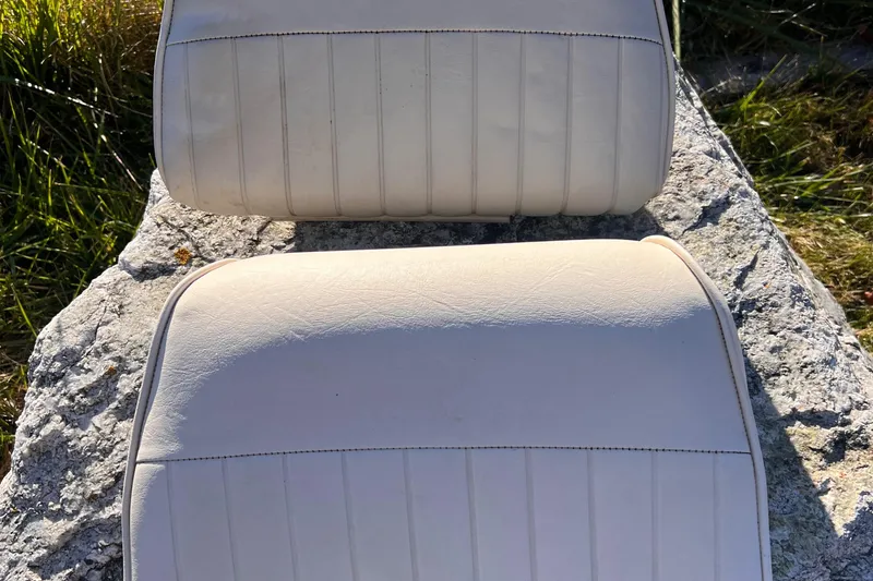 Slide: The Image of Boat seat cushions from a 2001 Grady-White Sportsman 180 on a rock. - 12