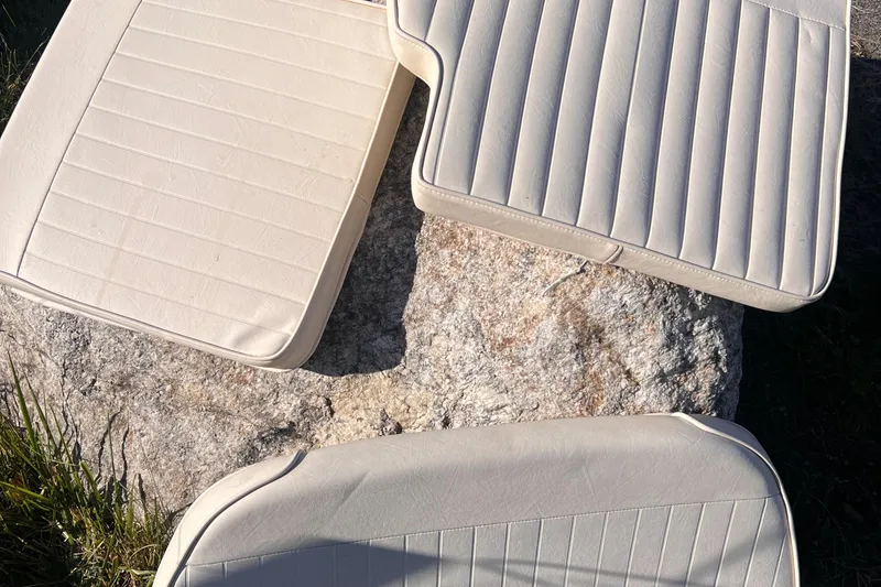 Slide: The Image of Boat seat cushions from a 2001 Grady-White Sportsman 180 on a rock. - 13