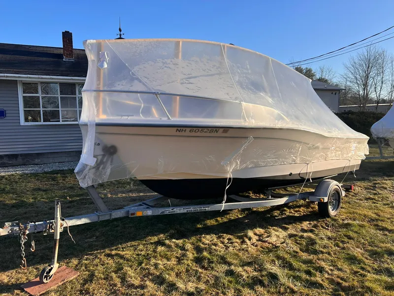 Slide: The Image of 2001 Grady-White Sportsman 180 boat covered on trailer in yard. - 15