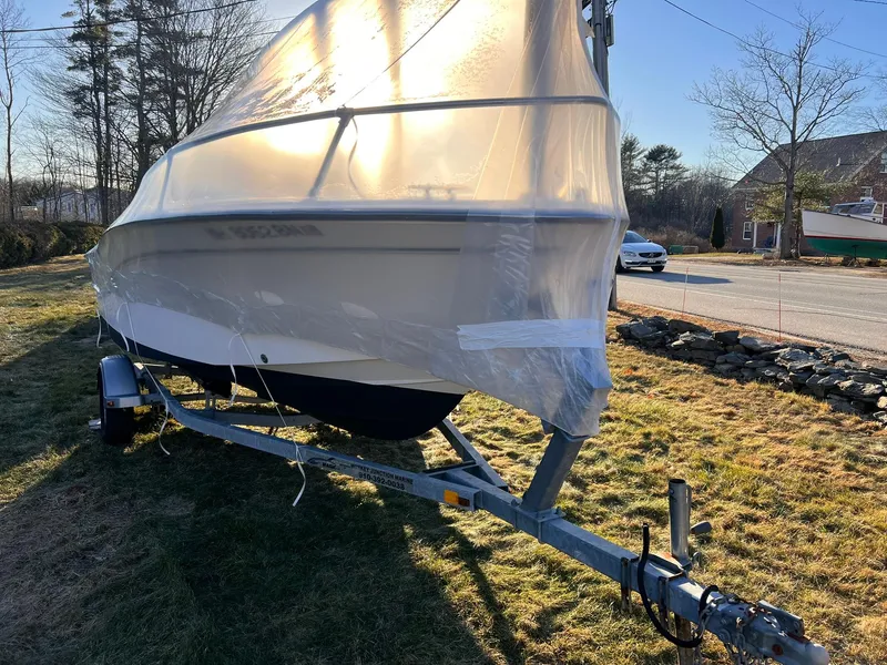 Slide: The Image of 2001 Grady-White Sportsman 180 boat covered on trailer, parked outdoors. - 17