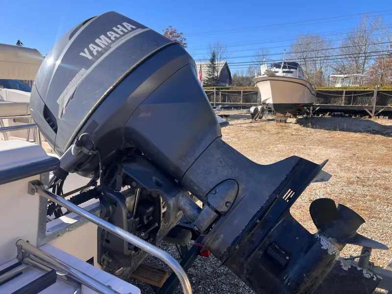 Slide: The Image of 2001 Grady-White Sportsman 180 with Yamaha outboard motor in a boatyard. - 6