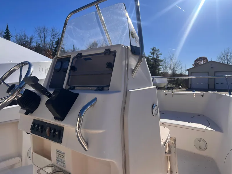 Slide: The Image of 2001 Grady-White Sportsman 180 boat console under clear blue sky. - 8