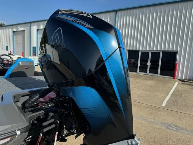 Slide: The Image of 2025 iKon LXL21 boat on trailer in parking lot, with truck in background. - 11