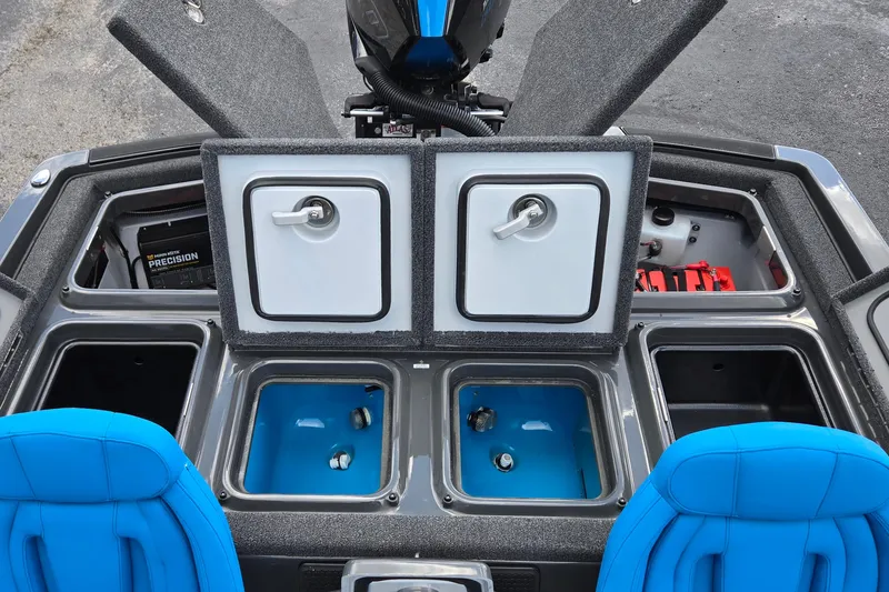 Slide: The Image of Interior of iKon LXL21 boat, featuring storage compartments and blue seating, 2025 model. - 18