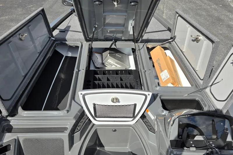 Slide: The Image of Open storage compartments in a 2025 iKon LXL21 boat, showcasing organized space. - 23