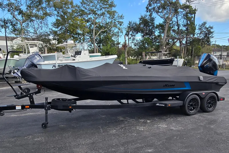 Slide: The Image of 2025 iKon LXL21 boat on trailer, covered, parked outdoors. - 27