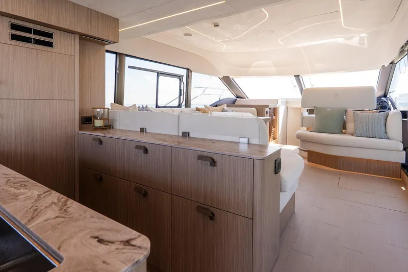 Slide: The Image of Luxurious interior of 2026 Prestige F5.7 yacht with modern wood finishes and plush seating. - 51