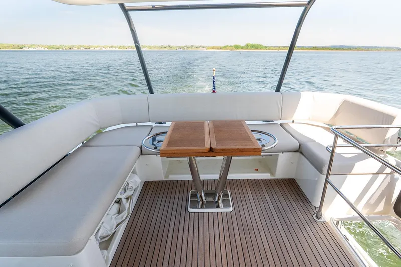 Slide: The Image of Luxurious Prestige F5.7 yacht deck with seating and table, cruising on serene waters, 2026 model. - 35