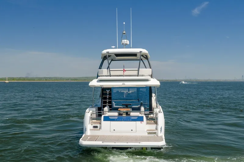Slide: The Image of Luxury Prestige F5.7 yacht cruising on open water, 2026 model. - 5