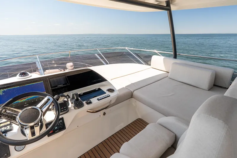 Slide: The Image of Luxurious Prestige F5.7 yacht interior, 2026 model, featuring a sleek helm and comfortable seating. - 27
