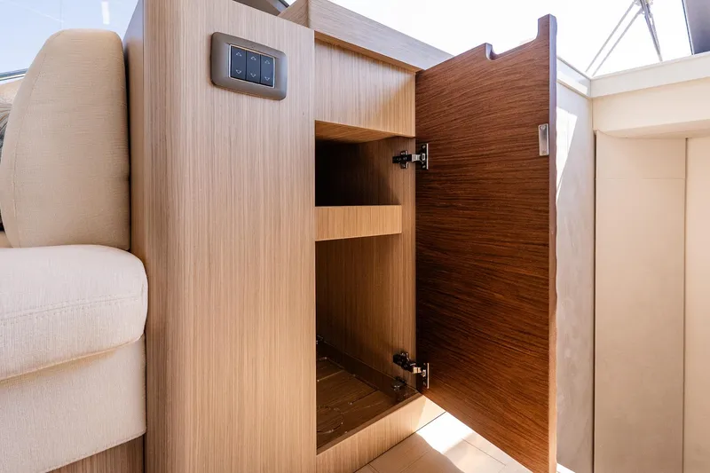 Slide: The Image of Open wooden cabinet in 2026 Prestige F5.7 yacht interior, showcasing modern design and storage. - 59