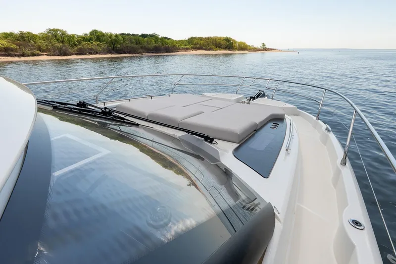 Slide: The Image of Luxury Prestige F5.7 yacht deck, 2026 model, cruising near a scenic shoreline. - 14