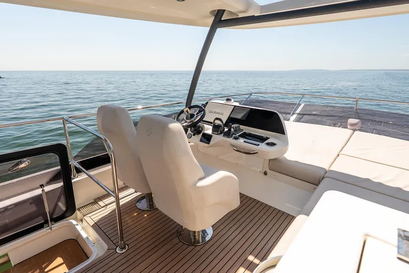 Slide: The Image of Luxurious 2026 Prestige F5.7 yacht helm with modern navigation system, overlooking serene ocean. - 21