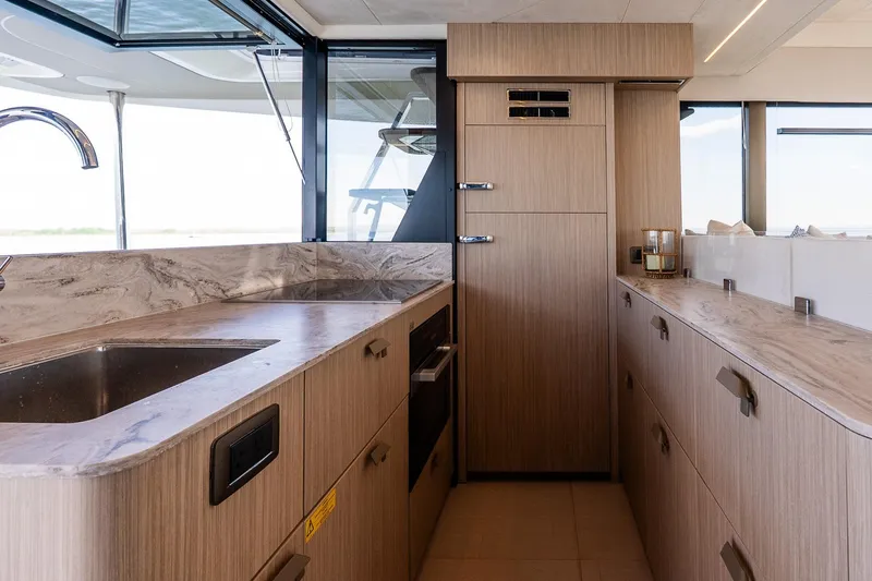 Slide: The Image of Modern kitchen interior on 2026 Prestige F5.7 yacht, featuring sleek countertops and cabinetry. - 50