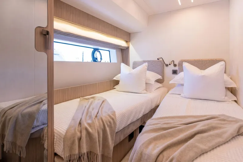 Slide: The Image of Luxurious twin cabin in 2026 Prestige F5.7 yacht with elegant bedding and modern lighting. - 82