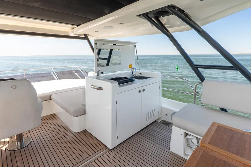 Slide: The Image of Luxurious Prestige F5.7 yacht interior, featuring modern seating and kitchenette, 2026 model. - 34