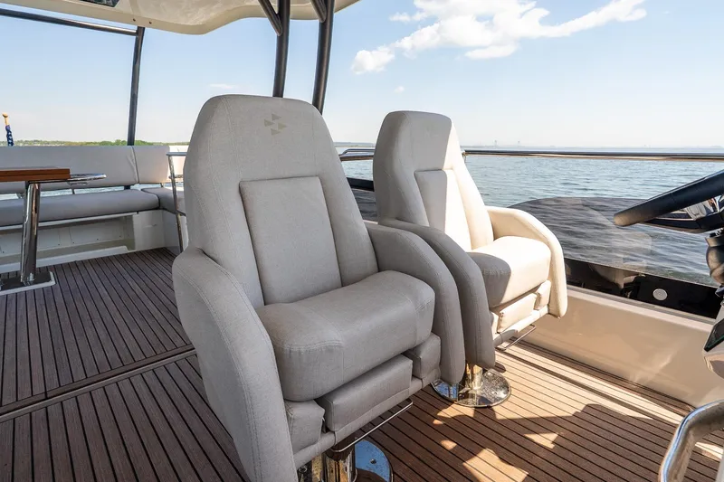 Slide: The Image of Luxurious seating on the 2026 Prestige F5.7 yacht with scenic ocean view. - 23