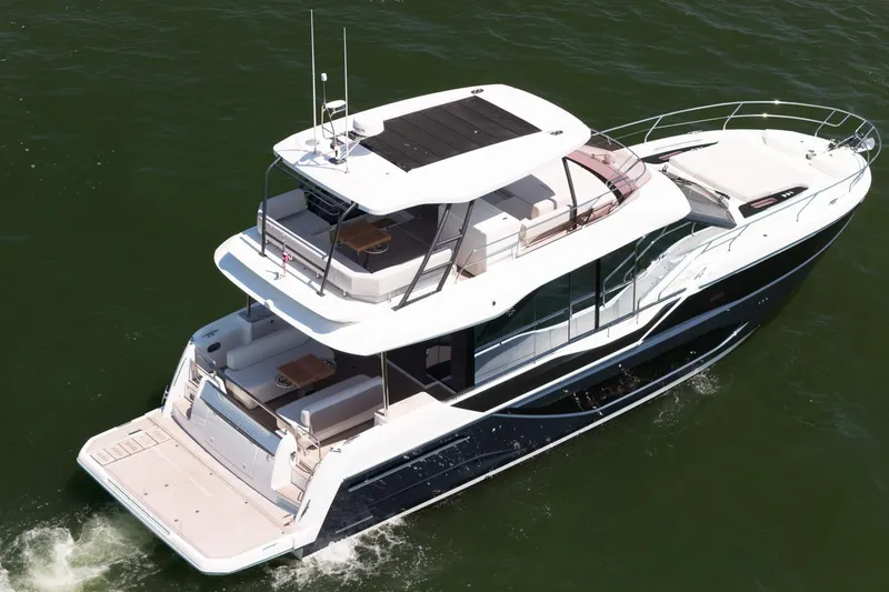 Slide: The Image of Luxurious 2026 Prestige F5.7 yacht cruising on open water, showcasing sleek design and spacious decks. - 12