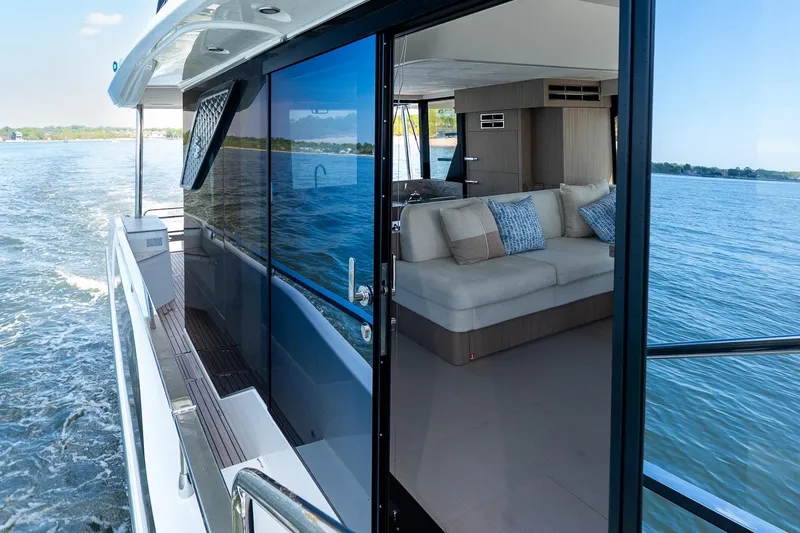 Slide: The Image of Prestige F5.7 yacht interior with sofa, cruising on open water, 2026 model. - 36