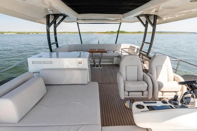 Slide: The Image of Luxurious 2026 Prestige F5.7 yacht interior with plush seating and modern controls on open water. - 32
