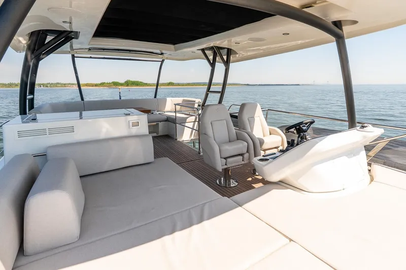Slide: The Image of Luxurious 2026 Prestige F5.7 yacht interior with modern seating and helm, overlooking serene waters. - 20