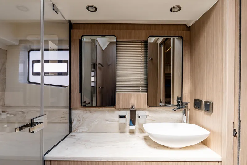 Slide: The Image of Modern yacht bathroom with sleek design, featuring a vessel sink and mirrored cabinets in Prestige F5.7, 2026. - 71
