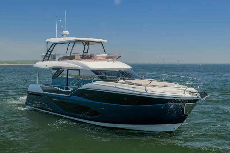 Slide: The Image of Luxurious 2026 Prestige F5.7 yacht cruising on open water under clear blue skies. - 3