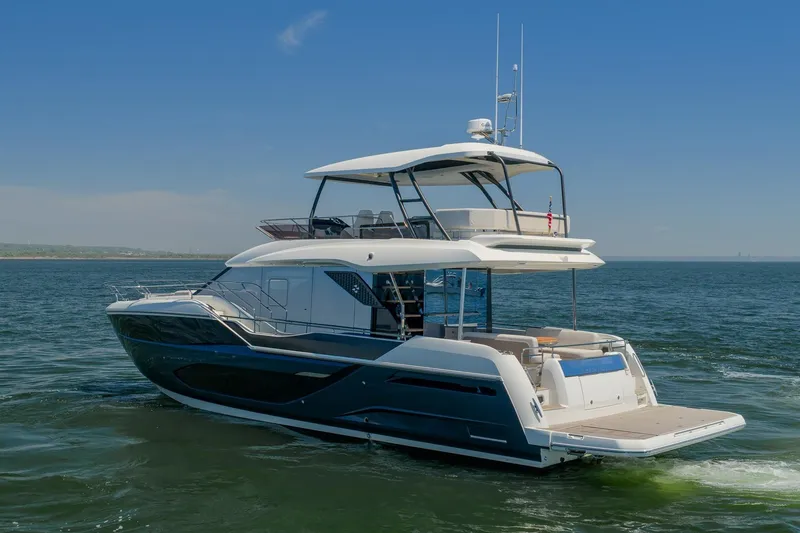 Slide: The Image of Luxurious 2026 Prestige F5.7 yacht cruising on open water under clear blue skies. - 8