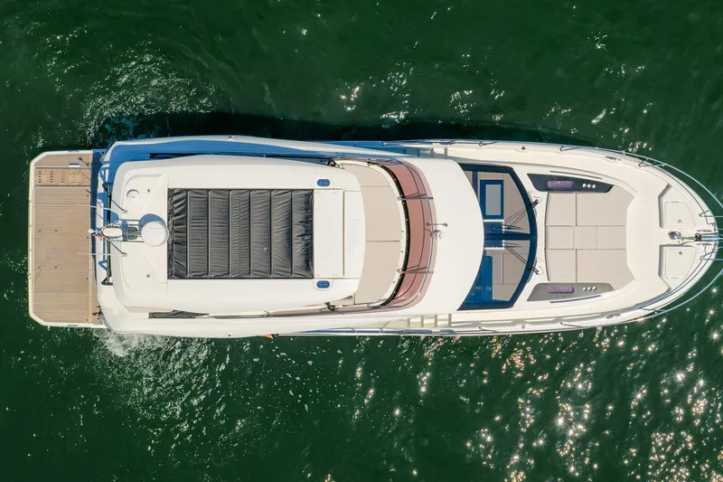Slide: The Image of Aerial view of 2026 Prestige F5.7 yacht cruising on green water. - 10